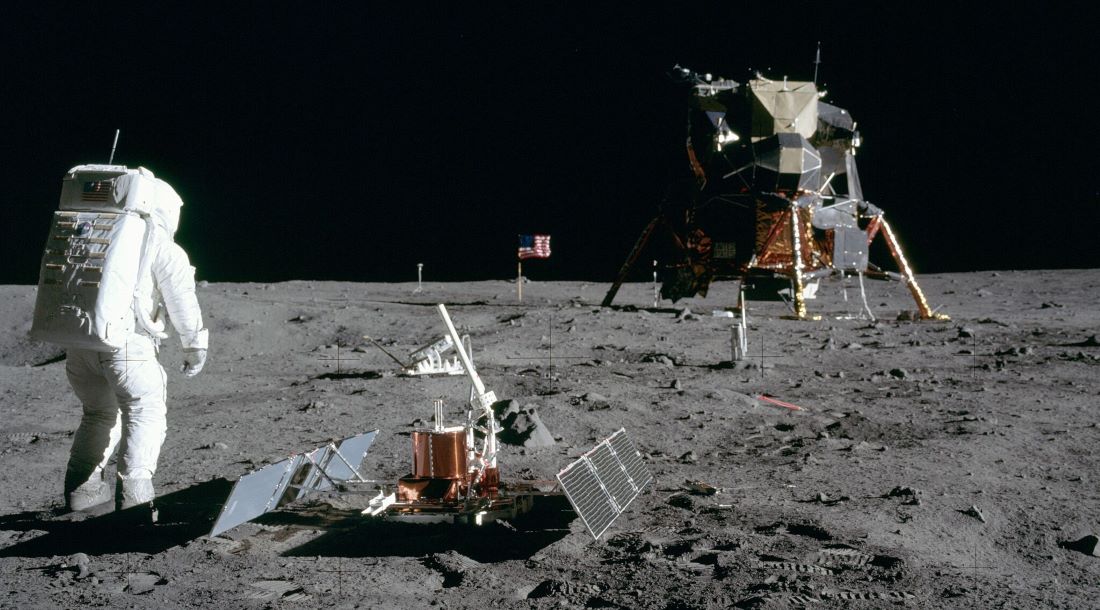 Aldrin next to the Passive Seismic Experiment Package with the Lunar Module Eagle in the background